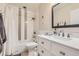 Well-lit bathroom features a sleek vanity with marble countertop, modern fixtures, and shower over tub at 3144 S Wheeling Way # 401, Aurora, CO 80014