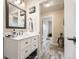 Well-appointed bathroom with a modern vanity, sleek fixtures, and a glimpse of the adjacent hallway at 3144 S Wheeling Way # 401, Aurora, CO 80014