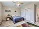 Serene bedroom featuring light wood-look floors, a ceiling fan, and ample closet space for storage at 3144 S Wheeling Way # 401, Aurora, CO 80014