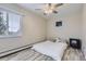 Neutral bedroom with hardwood floors, ceiling fan, window with blinds, and a cozy floor-level bed at 3144 S Wheeling Way # 401, Aurora, CO 80014