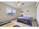 Bright bedroom features a ceiling fan, large window and sliding door closet, providing ample storage space at 3144 S Wheeling Way # 401, Aurora, CO 80014