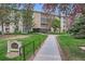 Well-manicured condo building with lawn and garden, featuring flowering trees in season at 3144 S Wheeling Way # 401, Aurora, CO 80014