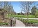 Scenic walkway leading to a lush golf course, showcasing the community's outdoor amenities and landscape at 3144 S Wheeling Way # 401, Aurora, CO 80014