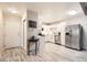 Welcoming view of the kitchen showcasing modern appliances and white cabinets in an open-concept layout at 3144 S Wheeling Way # 401, Aurora, CO 80014