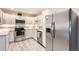Well-lit kitchen boasts stainless steel appliances, white cabinets, and modern countertops at 3144 S Wheeling Way # 401, Aurora, CO 80014