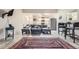 Bright living area with kitchen view, offering a comfortable sofa, barstools, and colorful rug on wood floors at 3144 S Wheeling Way # 401, Aurora, CO 80014