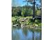 Scenic pond with lush greenery, rocks, and a gentle waterfall in a peaceful community setting at 3144 S Wheeling Way # 401, Aurora, CO 80014