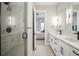 Modern bathroom with double vanity, walk-in shower and doorway to main bedroom at 3550 Uinta St # 6, Denver, CO 80238