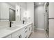 Elegant bathroom with double sinks, modern lighting, and glass-enclosed shower at 3550 Uinta St # 6, Denver, CO 80238