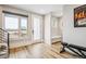 Bright foyer with wood floors, modern staircase, and built-in bench offers a welcoming entrance at 3550 Uinta St # 6, Denver, CO 80238