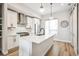 Bright kitchen with an island, pendant lighting, stainless steel appliances, and light wood flooring at 3550 Uinta St # 6, Denver, CO 80238