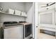 Convenient laundry room with modern washer and dryer, a shelf, and access to the bedroom at 3550 Uinta St # 6, Denver, CO 80238