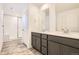 Bathroom featuring a double vanity, modern fixtures, and a glass-enclosed shower at 2190 S Haleyville Way, Aurora, CO 80018