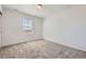 Empty bedroom with neutral walls, carpeted floors and natural light streaming in from one window at 2190 S Haleyville Way, Aurora, CO 80018