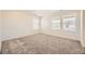 Carpeted bedroom featuring neutral walls and bright, natural light from two windows at 2190 S Haleyville Way, Aurora, CO 80018
