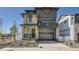 Modern two-story home with a stone and gray facade, covered porch and a two car garage at 2190 S Haleyville Way, Aurora, CO 80018