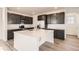 Well-lit modern kitchen with white countertops, dark cabinets, stainless steel appliances and spacious island at 2190 S Haleyville Way, Aurora, CO 80018