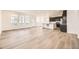 Open-concept living area featuring new wood floors, natural light, and a modern kitchen with a center island at 2190 S Haleyville Way, Aurora, CO 80018