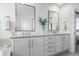 Bathroom featuring dual vanities with granite countertops, white cabinets and modern fixtures at 8075 S Vandriver Way, Aurora, CO 80016