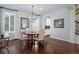 Elegant dining room featuring hardwood floors, a round wood table, and modern light fixtures at 8075 S Vandriver Way, Aurora, CO 80016