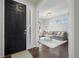 Inviting entryway leading to a living room with hardwood floors, modern lighting, and neutral decor at 8075 S Vandriver Way, Aurora, CO 80016