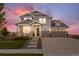 Charming two-story home with a welcoming front porch and a two car garage at 8075 S Vandriver Way, Aurora, CO 80016