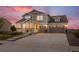 Charming two-story home with a welcoming front porch and a two car garage at 8075 S Vandriver Way, Aurora, CO 80016