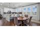Open-concept kitchen and dining area featuring a center island, granite countertops, and stainless steel appliances at 8075 S Vandriver Way, Aurora, CO 80016