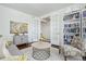 Inviting living room boasts ample seating, stylish decor, and convenient access through elegant French doors at 8075 S Vandriver Way, Aurora, CO 80016
