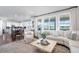 Bright living room with lots of windows, modern decor, and an open floor plan at 8075 S Vandriver Way, Aurora, CO 80016