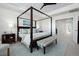 Spacious primary bedroom boasts a four-poster bed, soft colors, and a serene ambiance at 8075 S Vandriver Way, Aurora, CO 80016