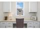 Functional office nook with granite counters, storage cabinets, and a well-lit window creates an ideal workspace at 8075 S Vandriver Way, Aurora, CO 80016