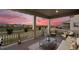 Covered patio featuring outdoor furniture, string lights, and scenic views of the surrounding neighborhood and golf course at 8075 S Vandriver Way, Aurora, CO 80016