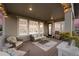 A covered patio boasts an outdoor dining area, grill, and scenic neighborhood views through large windows at 8075 S Vandriver Way, Aurora, CO 80016