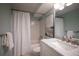 Bright bathroom featuring a marble vanity, bathtub with shower and stylish decor at 1090 N Lafayette St # 305, Denver, CO 80218