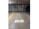 Underground parking garage spot featuring a parking space and concrete wall, and nearby car at 1090 N Lafayette St # 305, Denver, CO 80218