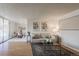 Open living room featuring hardwood floors, a modern sofa, and access to the dining area at 1090 N Lafayette St # 305, Denver, CO 80218