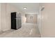 Spacious basement area with neutral walls and carpet, featuring a refrigerator and offering ample flexible space at 7511 Locust St, Commerce City, CO 80022