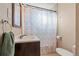 Cozy bathroom featuring floral shower curtain, sink vanity, and modern fixtures at 7511 Locust St, Commerce City, CO 80022