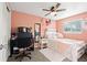 Charming bedroom with pink walls, a white bed, and a ceiling fan, designed for comfort and relaxation at 7511 Locust St, Commerce City, CO 80022