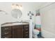 Bathroom with dark vanity and tiled shower at 3428 S Sherman St, Englewood, CO 80113