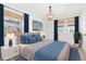 Virtually staged bedroom with blue accents at 3428 S Sherman St, Englewood, CO 80113