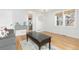 Living room with hardwood floors, gray couch, and kitchen view at 3428 S Sherman St, Englewood, CO 80113