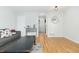 Hardwood floor living room with gray couch and view into hallway at 3428 S Sherman St, Englewood, CO 80113