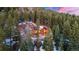 Mountain home, nestled in a forest, with snow-covered landscape showcasing its serene and private setting at 30 W Ranch Trl, Morrison, CO 80465