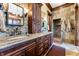 Bathroom boasts stone and wood, granite counters, double sinks, and walk in shower at 30 W Ranch Trl, Morrison, CO 80465