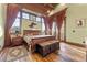 Bedroom with wood floors, large windows, curtains, and a wooden bed with an exterior view at 30 W Ranch Trl, Morrison, CO 80465