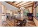 Spacious dining area with wood floors, timber beam accents, open to kitchen, with an exterior view at 30 W Ranch Trl, Morrison, CO 80465