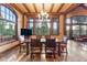 Open dining area with wood floors, timber beam accents, a large island and many windows for natural light at 30 W Ranch Trl, Morrison, CO 80465