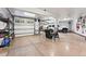 Spacious garage with epoxy floors, multiple doors, and ample storage space at 30 W Ranch Trl, Morrison, CO 80465